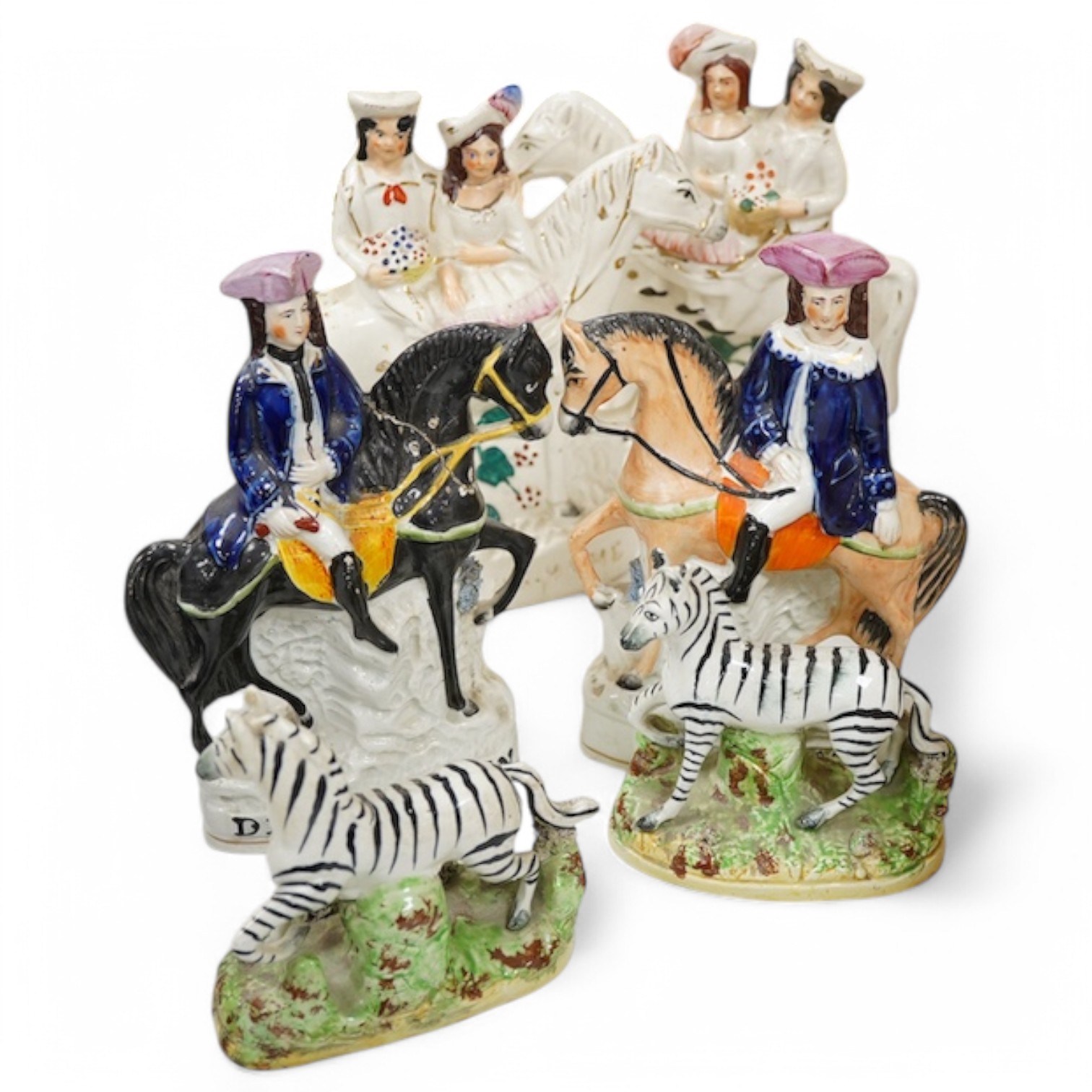 A pair of 19th century Staffordshire pottery models of Zebra, two pairs of Staffordshire pottery equestrian groups, largest 21cm high (6) Condition - some minor breaks and repairs